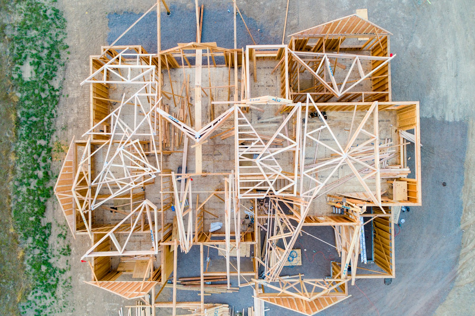 Aerial view of a custom home under construction during framing